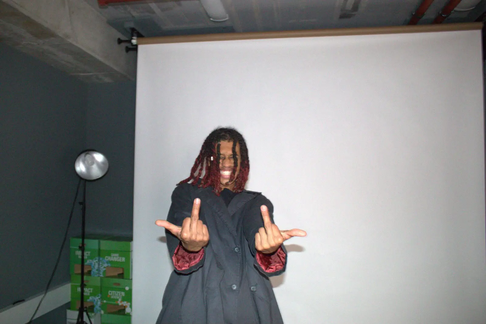 Artist posing in front of a studio backdrop
