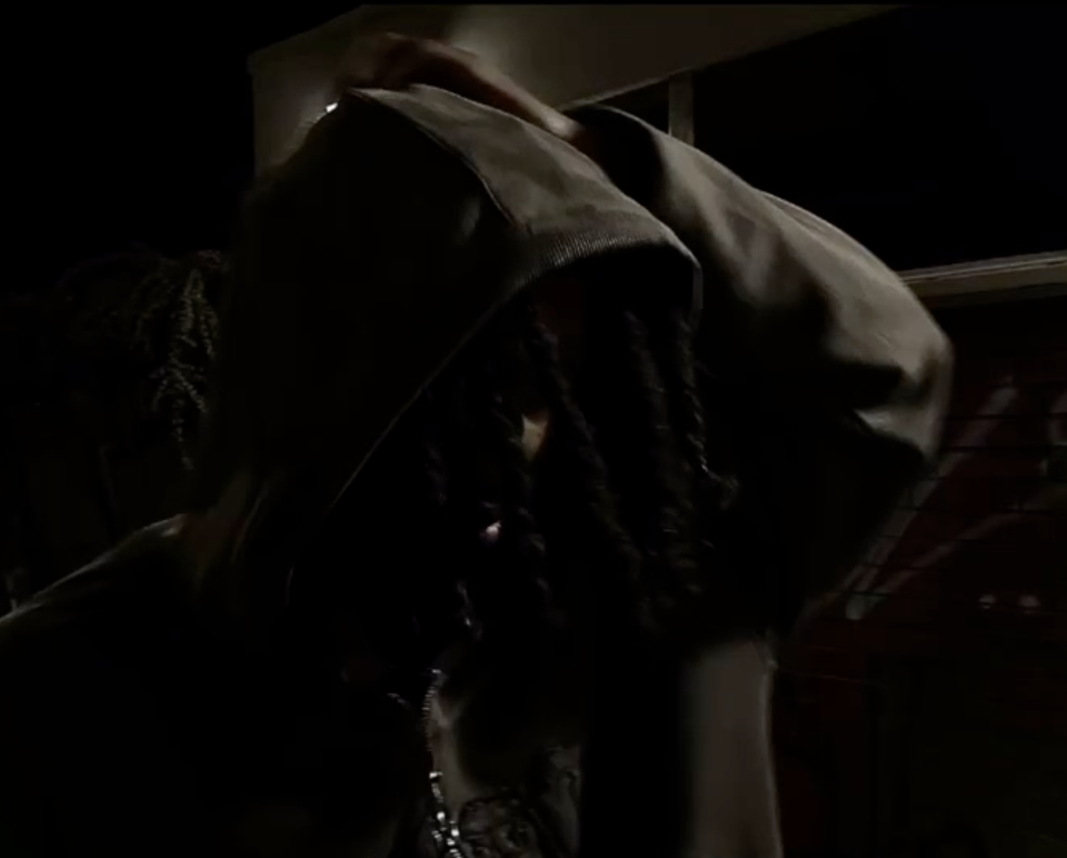 Dappie pulling a hood over his face in the dark